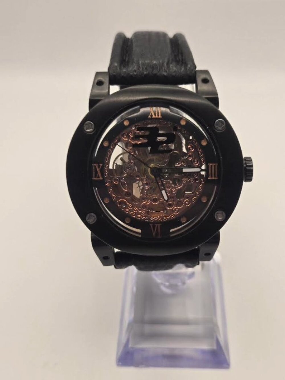 The 32 Degrees 46mm Automatic Skeleton Concave Black and Gold Watch is a luxurio